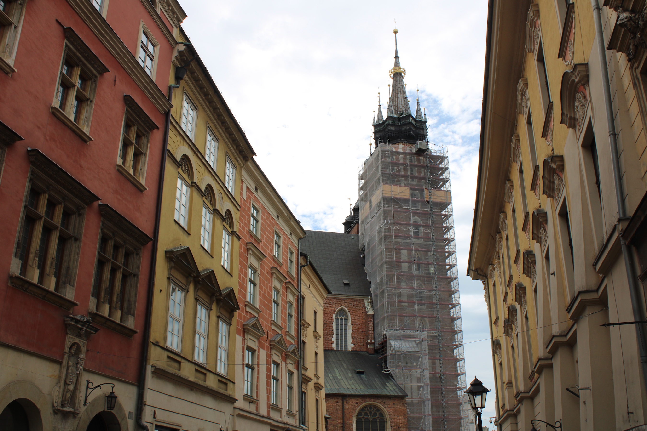 A tower is covered in scaffolding and transparent construction fabric