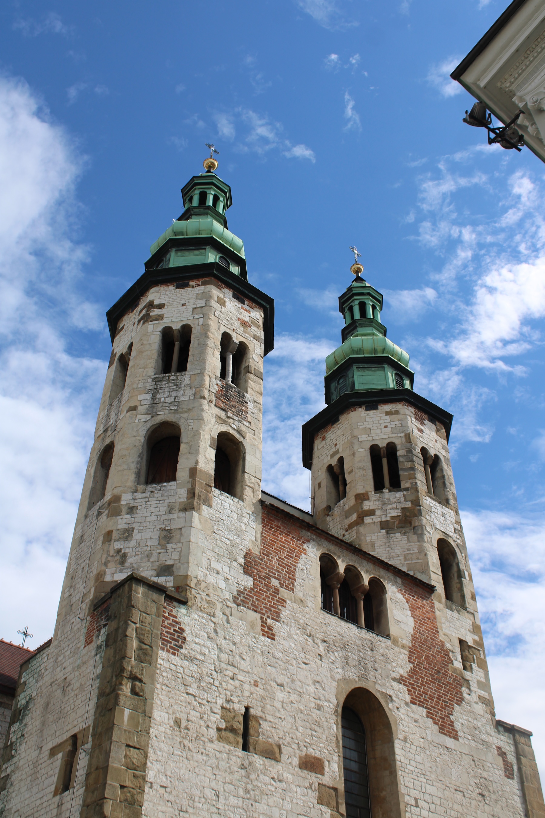 Two tall, glorious towers of a church on the walk to Wawel castle