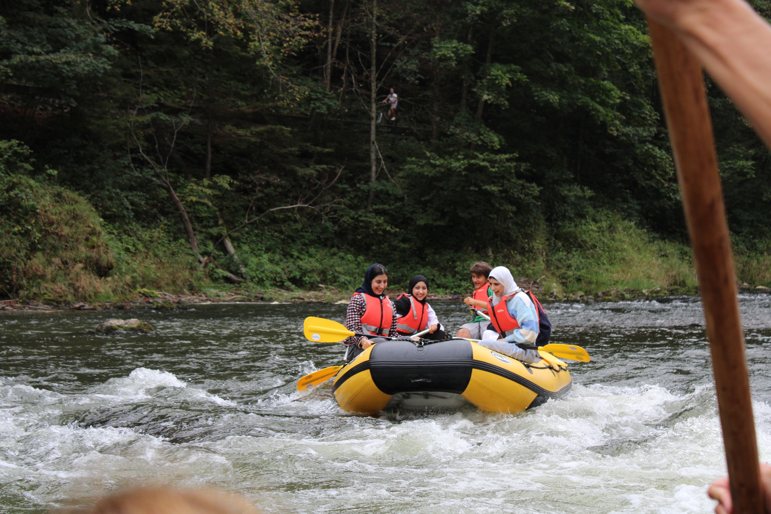 A family enjoys actual rafting.