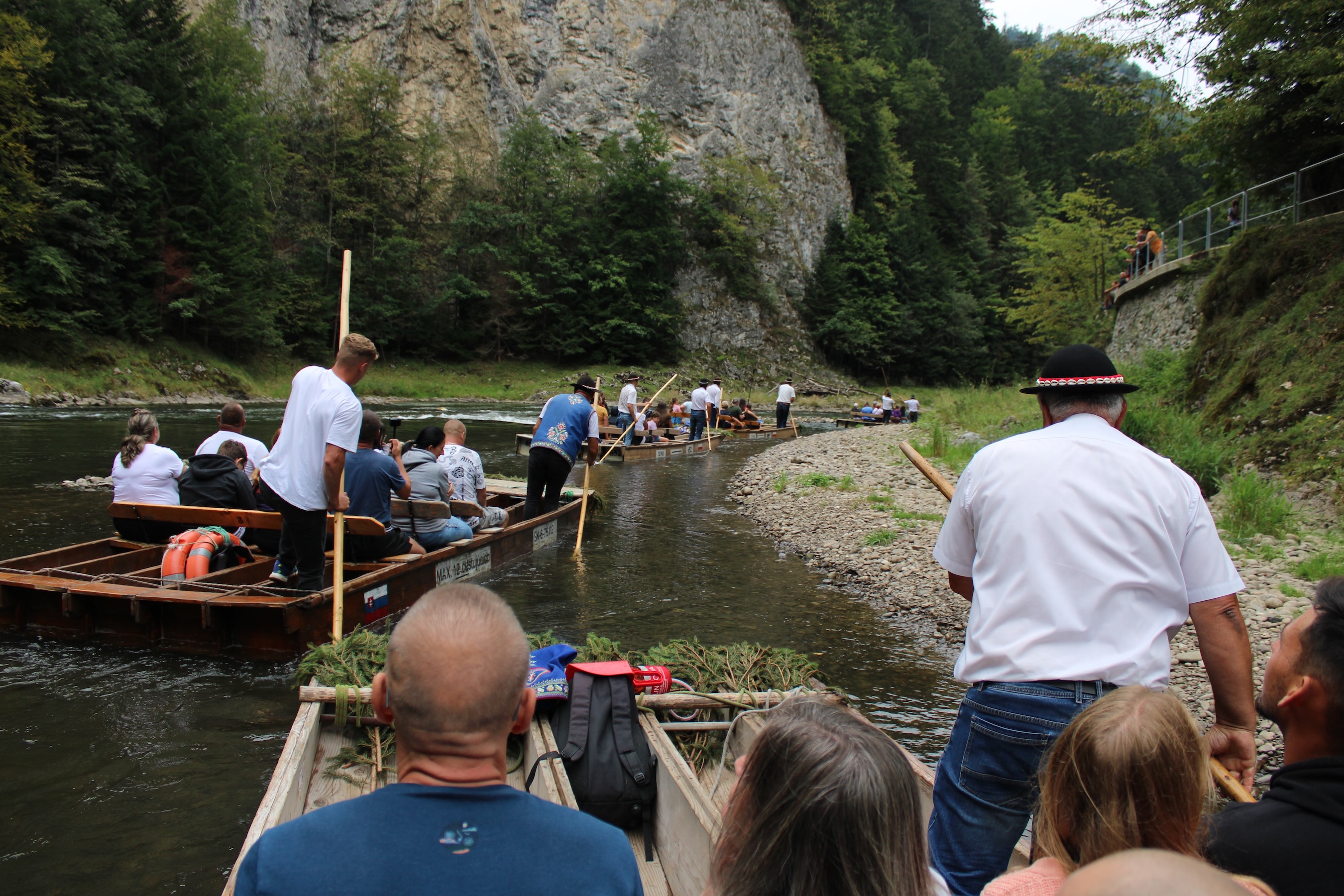 Roughly 10 tour boats alll just a few meters from each other going slowly around a bank in the river