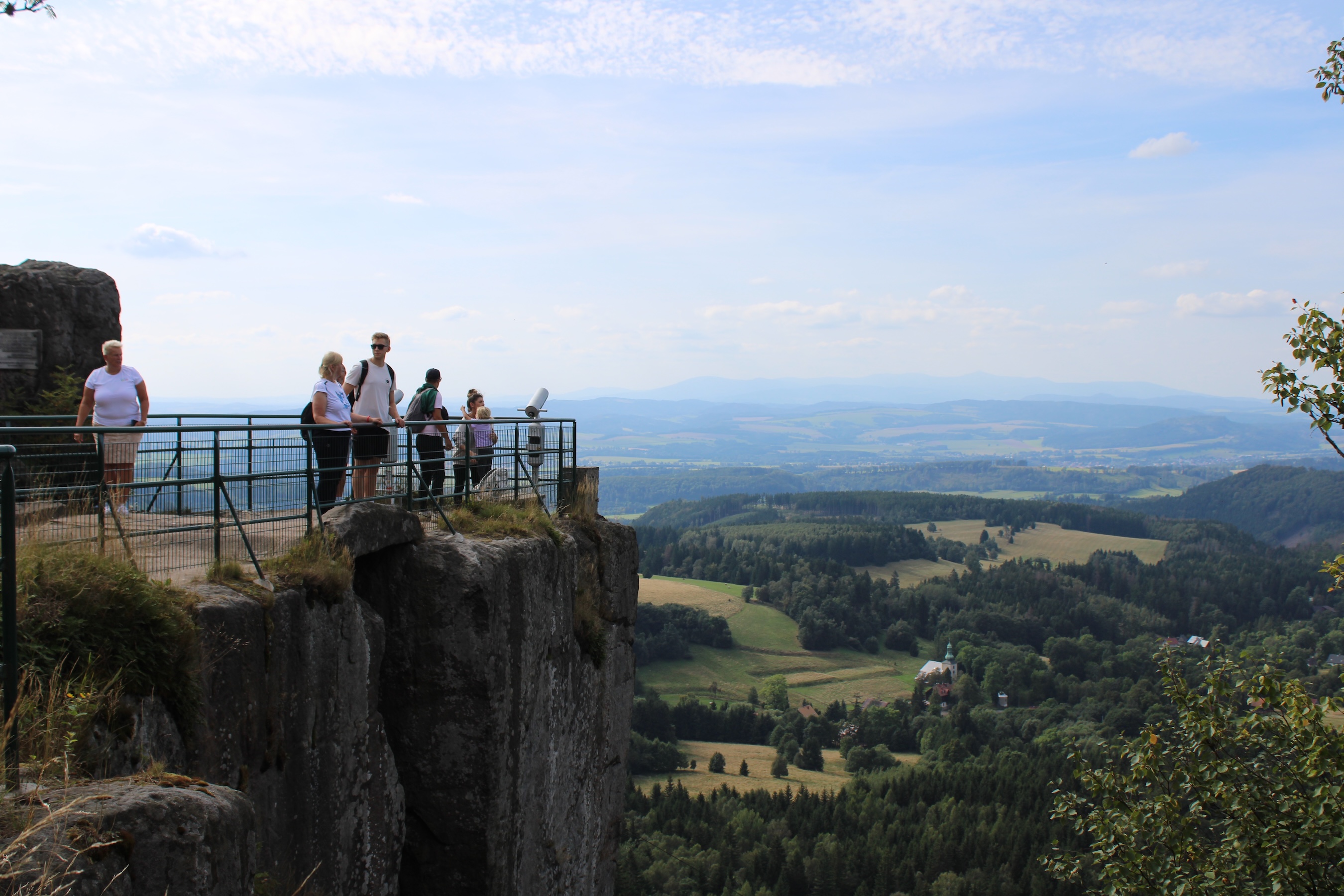 A viewing spot on the edge of the mountain we walked up. A sheer wall of rock is fenced off with tourists looking out.