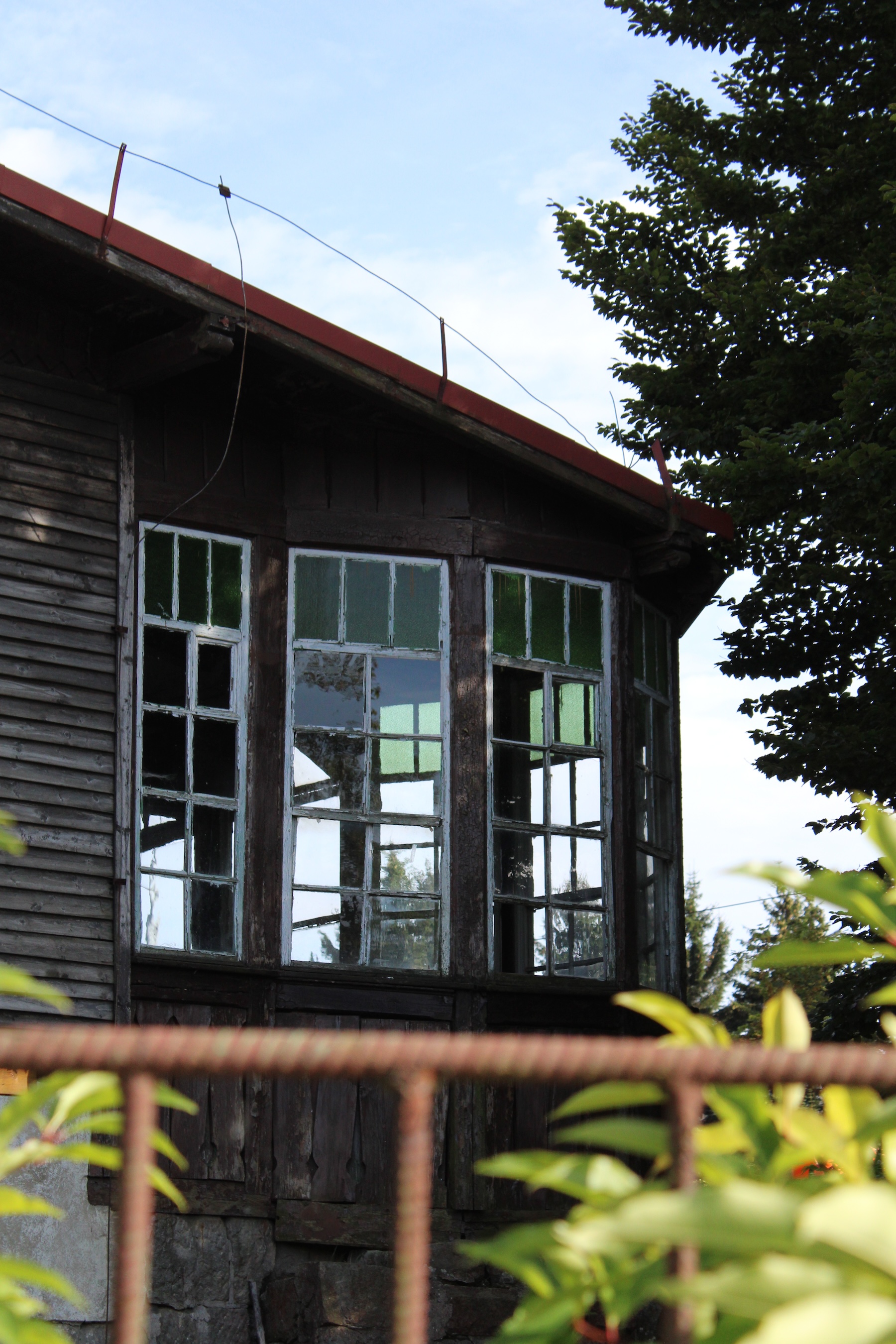An old wooden house with some stained glass windows
