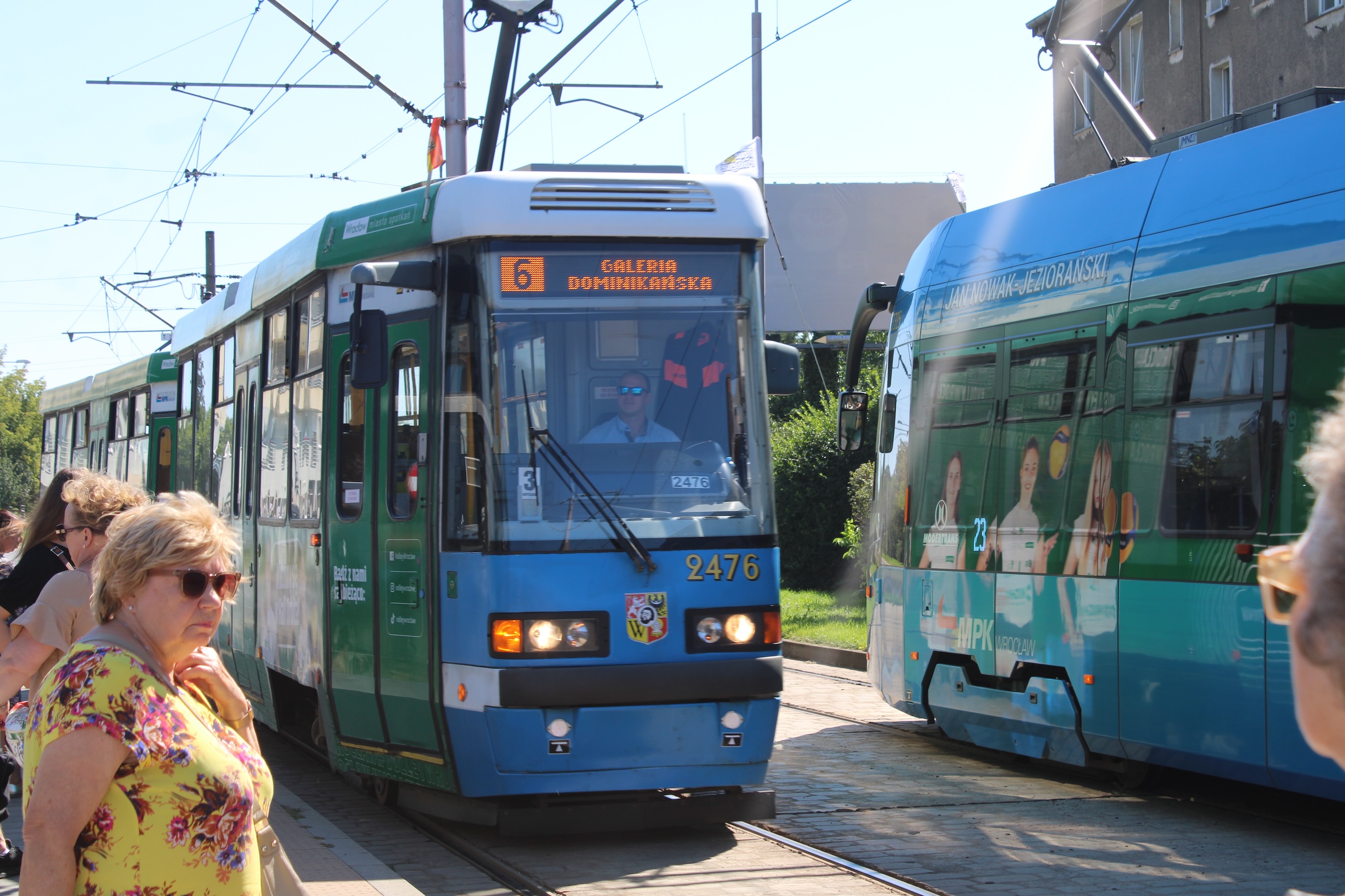 Two trams pass each other at a station